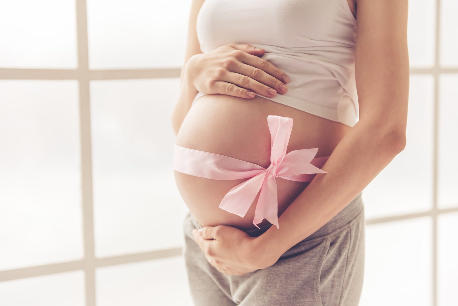 Cropped,Image,Of,Beautiful,Pregnant,Woman,Hugging,Her,Tummy,With