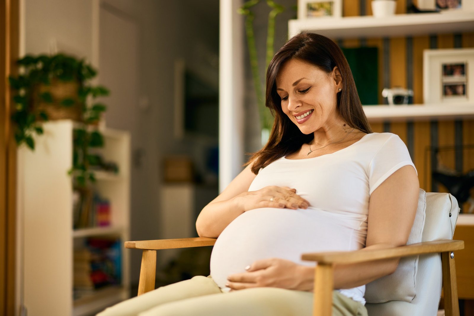 Pregnant woman seated by a window